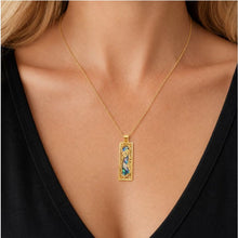 A woman wearing 14k gold Roman Glass Silver Mezuzah Pendant
