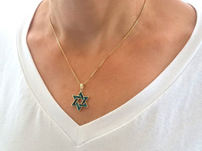 14k gold star of david pendant on women 