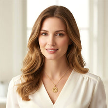 Woman wearing a gold necklace with a star pendant against a neutral background