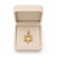 Gold star- of David shaped pendant in a beige jewelry box on a white background