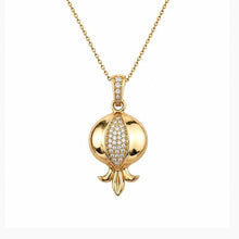 A gold pendant necklace featuring a pomegranate design with a pavé diamond accent on the center, suspended from a delicate gold chain against a plain white background.