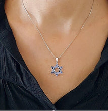 Woman wearing Star of David gold necklace with blue sapphire stones