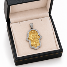 14K gold Jerusalem Hamsa pendant with a diamond-set white gold border displayed in an open black jewelry box