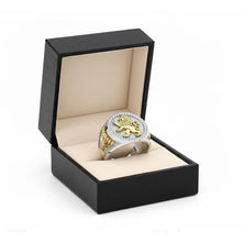 Gold and silver ring in a black box on a white background