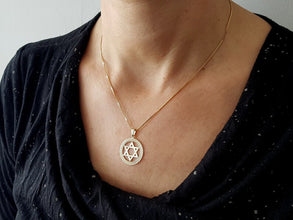Gold star of David pendant on women 