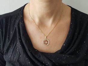 Gold star of David pendant on women 