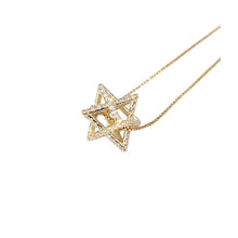 Gold geometric necklace on a white background