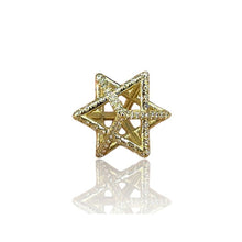 Gold star-shaped jewelry piece on a white background