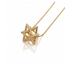 Gold star-shaped pendant on a chain against a white background