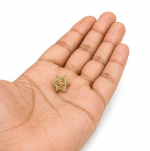 gold Merkaba star of David on a hand against a white background