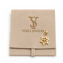 Gold Star of David pendant on a Yoels Jewelry branded pouch.