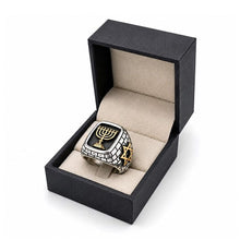Ring with Menorah design in a black box on a white background
