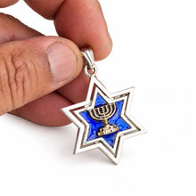 Blue enamel Star of David pendant with gold Menorah held between fingers