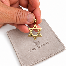 Gold Star of David pendant on hand 