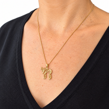 women wears gold chai pendant 