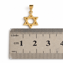 Gold Star of David pendant on a ruler
