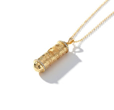Gold cylindrical pendant necklace on a white background