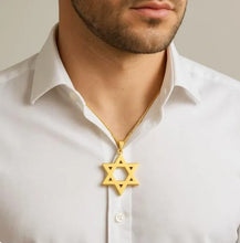 Man wearing a gold Star of David necklace on a plain background