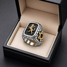 Silver ring with gold lion and star design in a black box