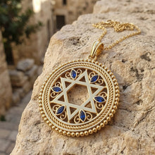 Gold necklace with a Star of David pendant on a stone surface