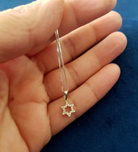 Tiny 14K gold Star of David pendant with lab diamonds on hand