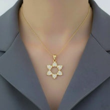 Gold necklace with a star-shaped pendant on a mannequin