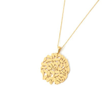 Gold necklace with a intricate pendant on a white background
