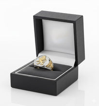 Gold and silver ring in a black box on a white background