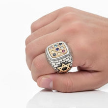 Hand wearing a decorative  hoshebnring with gemstones on a white background