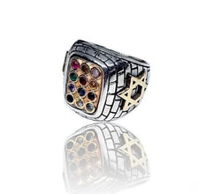 Silver ring with multicolored gemstones and star design on a white background
