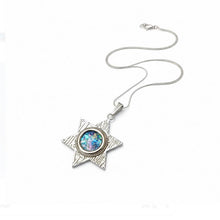 Silver necklace with a star-shaped pendant on a white background