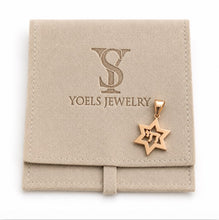 Rose gold Star of David pendant on a Yoels Jewelry branded pouch.