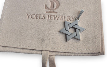 Silver star-shaped pendant on a Yoels Jewelry branded card.