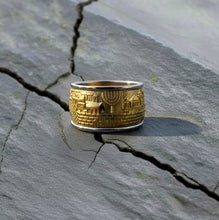 Jerusalem Gold ring with architectural design on a cracked stone surface