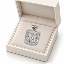 Silver Lion of Judah pendant displayed in an open cream jewelry gift box