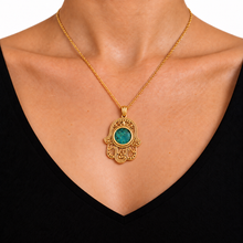 women wearing gold hamsa filigree pendant set with green eilat stone from Israel 