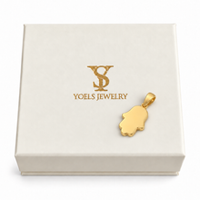 Small 14K yellow gold Hamsa pendant resting on a cream Yoels Jewelry gift box
