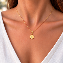Woman wearing a delicate 1.1 cm gold Star of David pendant with lab-grown diamond