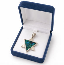 Jewelry box with a blue and green pendant inside
