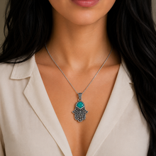 women wears Eilat stone hamsa pendant 