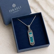 Silver necklace with a blue pendant in an open Israeli Jewelry box.