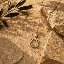 Gold  star of david heart-shaped pendant on a textured stone surface