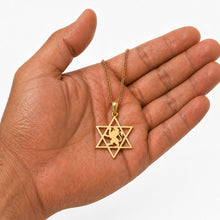 14k gold Star of David pendant with lion shown on hand for size reference jewish jewelry