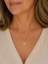 woman wearing 14k gold Star of David necklace with lion design elegant jewish jewelry
