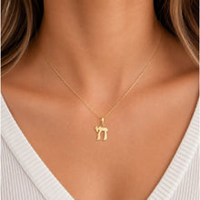 Woman wearing a  chai gold necklace with a pendant in a jewelry store.