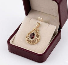 Women is wearing 14K yellow gold pomegranate pendant with amethyst