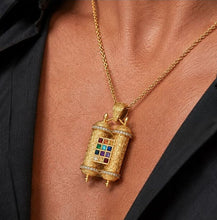 Man wearing a 14K gold Hoshen pendant with diamonds and Twelve Tribes gemstones