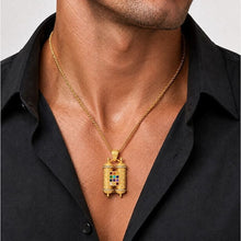 Man wearing a 14K gold Hoshen pendant with diamonds and Twelve Tribes gemstones