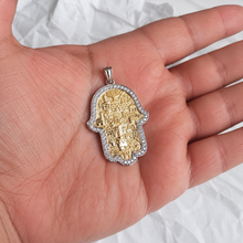 Gold Jerusalem Hamsa pendant on a palm