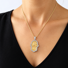 women is wearing  Jerusalem hamsa  pendant